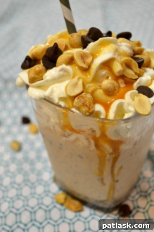 A refreshing Snickers Milkshake, overflowing with chocolate, peanuts, and caramel flavors.