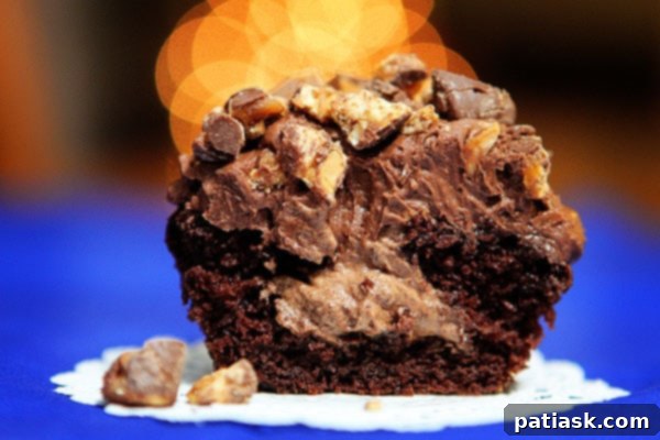 Decadent Snickers Cupcakes with rich chocolate mousse filling, a truly impressive dessert.