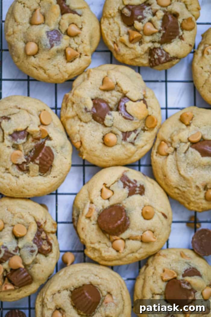 2020's 10 Most Loved Dessert Recipes 4 Peanut Butter Cup Explosion Cookies stacked on a cooling rack