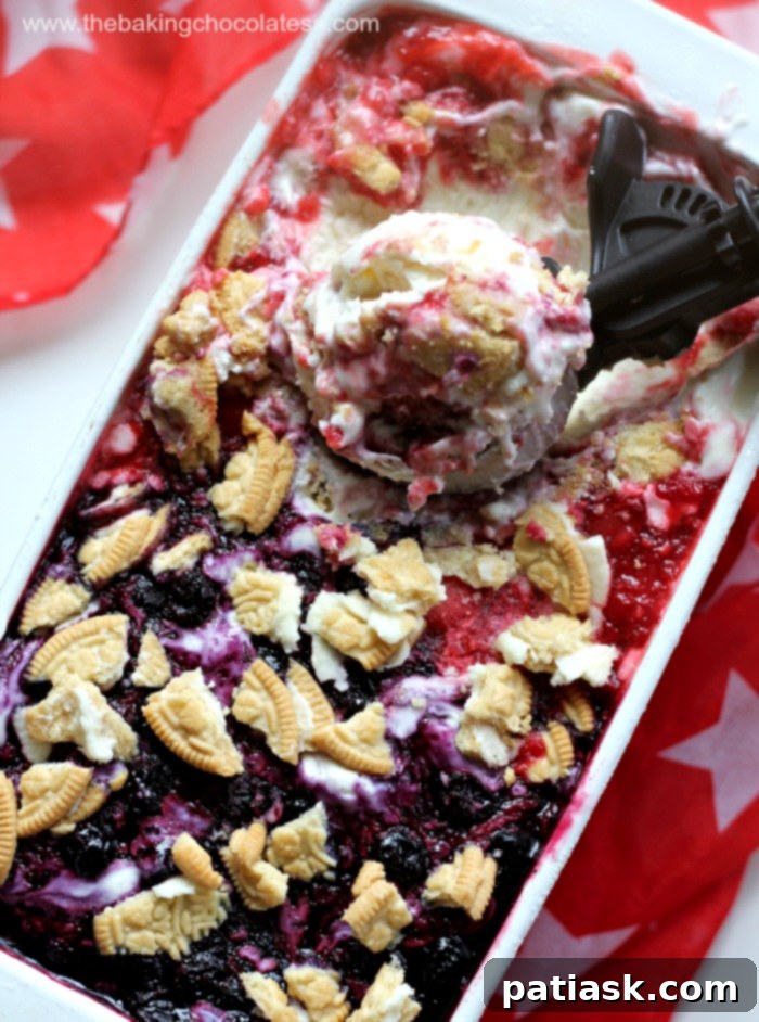 Triple Berry No-Churn Cheesecake Ice Cream 3 A close-up shot of a full loaf pan of 3 Berry Cheesecake Ice Cream, showing the enticing berry swirls before being served. Perfect for a summer treat.