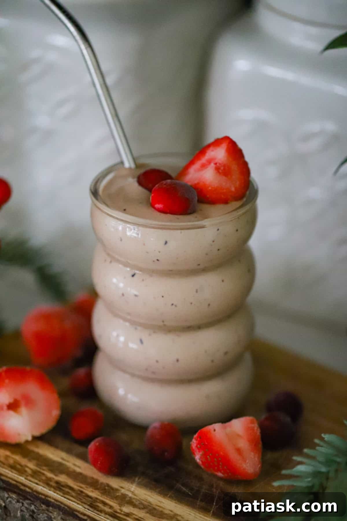 Bright Anti-Inflammatory Berry Power Smoothie 5 A tall glass filled with the vibrant cranberry strawberry smoothie